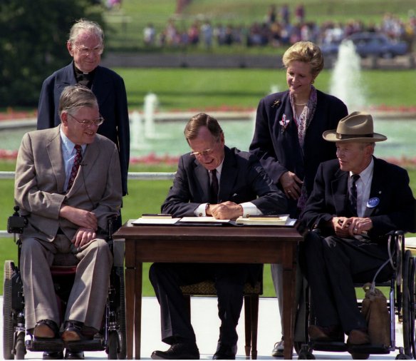 President George H. W. Bush signs the ADA, July 1990.